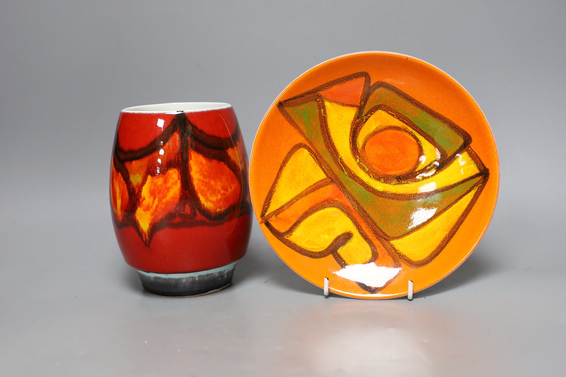 A Poole pottery orange and red abstract vase and plate, 20cm diameter